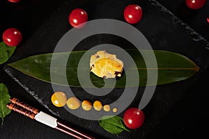 Traditional Japanese food - sushi, rolls and sauce on a black background. Top view.