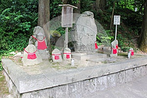 Traditional Japanese Jizo Statues Adorned With Red Bibs at Kiyomizudera Temple