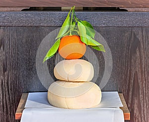 Traditional Japanese New Year decoration Kagami mochi topped by a daidai bitter orange.