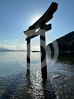 Traditional Japanese red torii gate standing in the sea in Seto Nakia national park