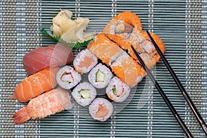 Traditional japanese sushi menu. Close-up of various kinds of sushi rolls with salmon, sashimi and other slices of raw fish and a