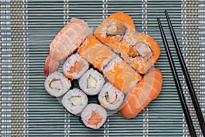 Traditional japanese sushi menu. Close-up of various kinds of sushi rolls with salmon, sashimi and other slices of raw fish and a