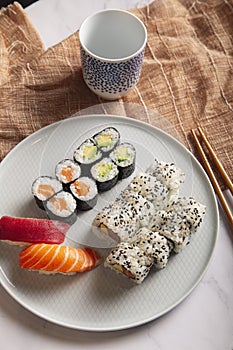 Traditional Japanese sushi mix served on a white plate