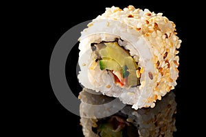 Traditional Japanese sushi rolls on black background with large reflection