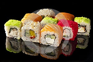 Traditional Japanese sushi rolls on black background with reflection set