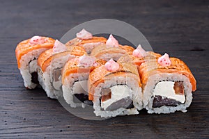 traditional Japanese sushi with salmon soft cheese avocado and red caviar garnished with creamy sauce. Japanese kitchen.