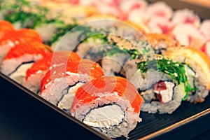 Traditional japanese sushi set serviced on black background. tasty set of sushi, nigiri, sashimi and maki.