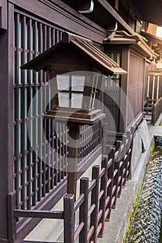 A traditional Japanese wooden lantern located in front of the house