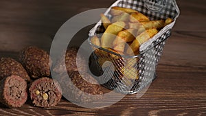 Traditional kebbe and French fries on brown table in lebanese restaurant