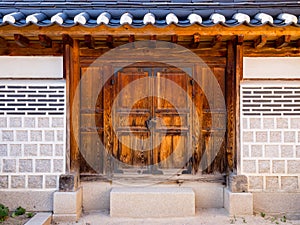 Traditional korean architecture, stone wall with wooden door in Gyeongbokgung Palace, Seoul, South Korea