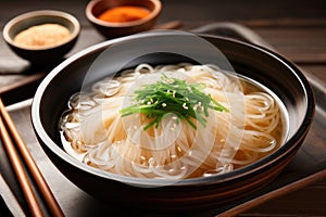 Traditional Korean Cold Noodles in Black Bowl with Chopsticks