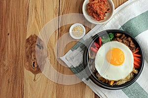 Traditional Korean Dish: Bibimbap Rice with Mix Sautee Vegetables, Beef,  and Egg. Served with Red Spicy Bibimbap Sauce and Sesame