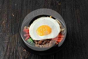 Traditional Korean dish: Bibimbap Rice with Mix Sautee Vegetables, Beef,  and Egg. Served with Red Spicy Bibimbap Sauce and Sesame