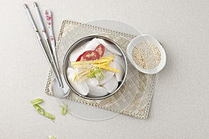 Traditional Korean food Tteokguk Rice cake soup with spoons and chopsticks, South Korea photo