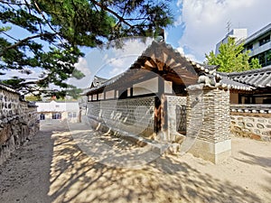 Traditional Korean Hanok Village building with old wooden buildings and stone wall in the afternoon in Seoul, South Korea