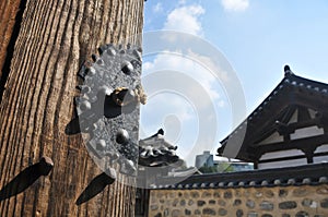 Traditional Korean Hanok Village building with old wooden door and metal lock in the afternoon in Seoul, South Korea