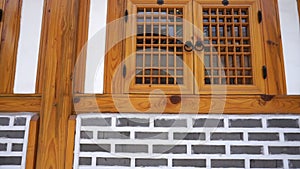 Traditional korean house Hanok in downtown old city of Seoul details of wood window and brick wall