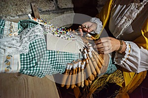 Traditional lace handcrafting with bobbins in Galicia