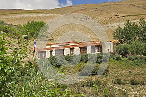 A traditional Ladakhi house amidst the greenery in a dry mountain of Zanskar Valley, Ladakh, INDIA