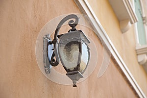 Traditional lamp post on the wall of a building