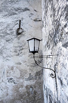 Traditional lamp on white and grey wall of Hohensalzburg Fort in Salzberg, Austria photo