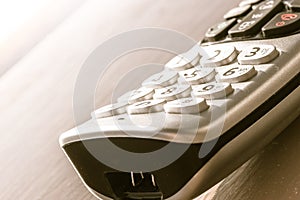 Traditional landline phone isolated on wooden desk background photo