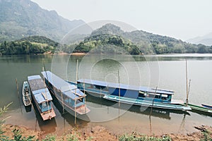 Traditional Laotian wooden slow boat on Nam Ou river near Nong Khiaw village, Laos