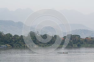 Traditional Laotian wooden slow boats on Mekong river near Luang Prabang, Laos