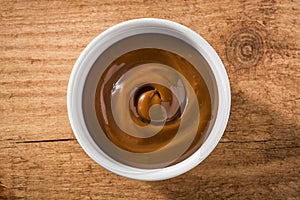 Traditional Latin American dulce de leche or manjar on wooden background. photo