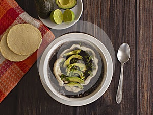 Traditional Latinamerica Black Beans Soup with Avocado and Cream including Homemade Flat Tortilla photo