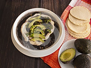 Traditional Latinamerica Black Beans Soup with Avocado and Cream including Homemade Flat Tortilla photo