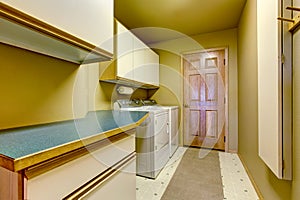 Traditional laundry room with tile floor, and washer dryer combo.