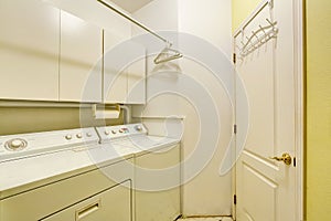Traditional laundry room with tile floor, and washer dryer combo.