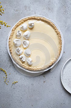 Traditional lemon tart with curd filling decorated with meringues
