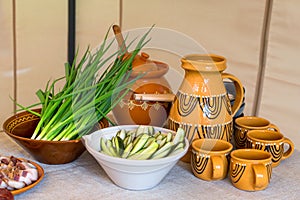 Traditional Lithuanian cuisine, table setting, homemade kvass, pickled cucumbers, green onions