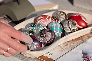 Traditional Lithuanian wooden colorful Easter eggs in a wicker basket