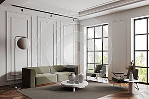 Traditional living room interior with chairs and couch near panoramic window