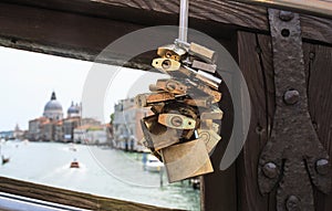 Traditional locks on bridge with blurred grand canal on backgrou