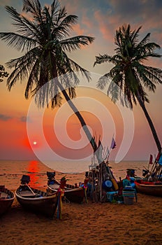 Traditional long tail boat on Pattaya beach at sunset, Thailand