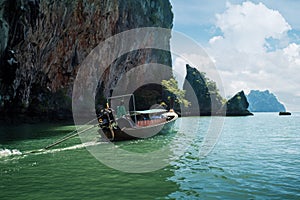 Traditional long thai boat near beautiful famous Phi Phi Islands, Thailand.