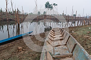 Traditional long wooden boat for fishing and transportation by river in Laos