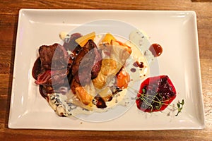 Traditional main course of sauteed reindeer with mashed potatoes and cranberries in Finland