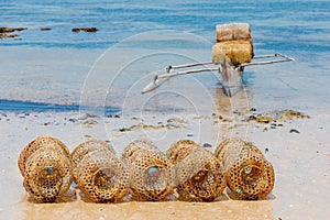 Traditional malagasy fishing boat with trap on beach