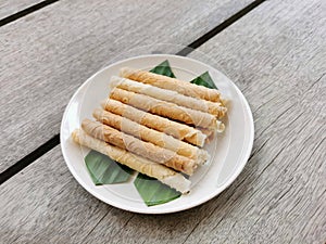 Traditional Malaysian cookies snack called "Kuih Kapit" served for Eid Fitri, Eid Adha and ramadhan on wooden palette.