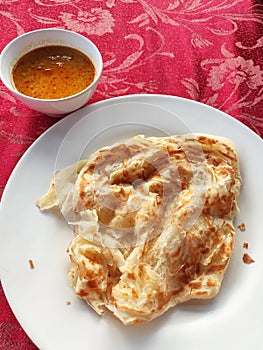 Traditional Malaysian signature flatbread food called roti canai.  This is type of pancake made from mix of flour, egg and water.