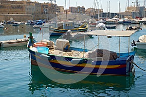 The traditional Maltese boat Luzzu moored in the Kalkara creek