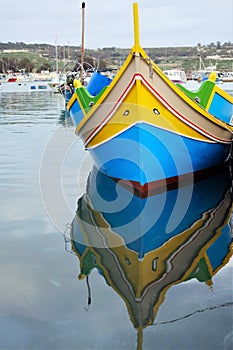 Traditional maltese fishing boat `luzu` in Marsaxlokk