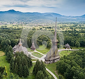 Aerial panoramic view of traditional ancient Maramures wooden orthodox church in Transylvania with highest wooden