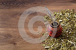 Traditional mate made of calabash over a wooden table.