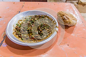 Traditional meal in Sudan - fuul (stew of cooked fava beans) and brea